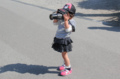 A little girl using a big camera in the Gassho-zukuri Village in Shirakawa-go tucked away in the surrounding mountains