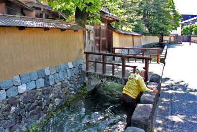 Man retrieving an object from the Onosho Canal - seen as we entered the Naga-machi Samurai District in Kanazawa