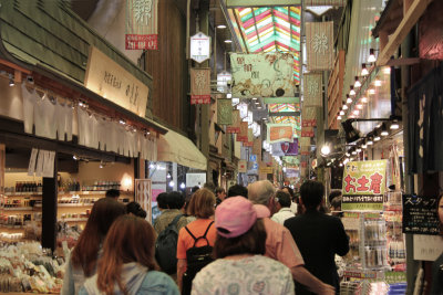 Judy (pink hat) with Sallie and John in front of her at the busy Nishiki Market in Kyoto