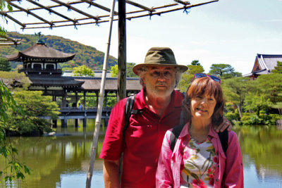 Judy and Richard near the roofed bridge over a pond at the garden of the Heian-jingu Shrine in Kyoto