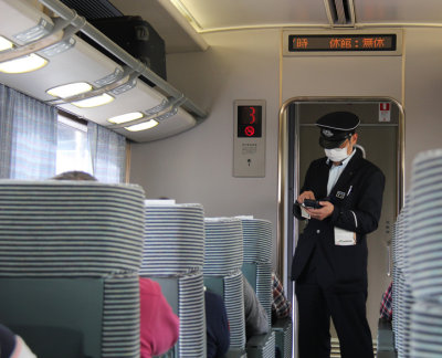Conductor on our train - while traveling from Nara back to Kyoto