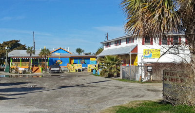Coco's Sunset Grille (blue and yellow structure) - freshly caught fish for sale in the white structure - Tybee Island