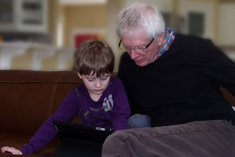 Granddad gets a lesson on the iPad, Photo by Gladys