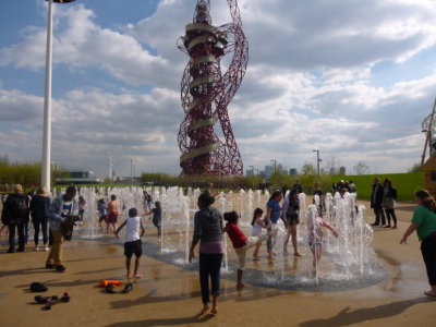 Children playing in the fountains in front of the Orbit Tower