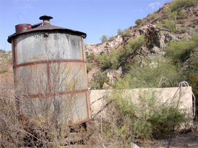 Water storage..concrete tank in back. Complete with solar panel-pump!