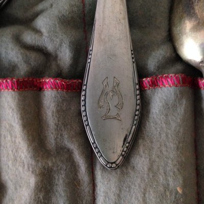 Detail of ML embossed silverware