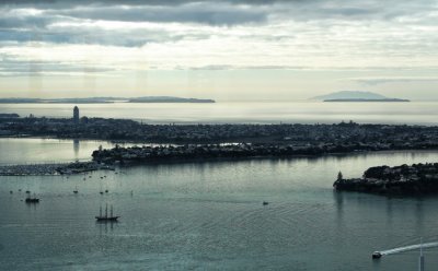 This photo looks more to the north.
Here you can see Little Barrier behind Tiritiri Island. 
Then Whangaparaoa, and further north, with Bayswater and Takapuna on the North Shore in the foreground