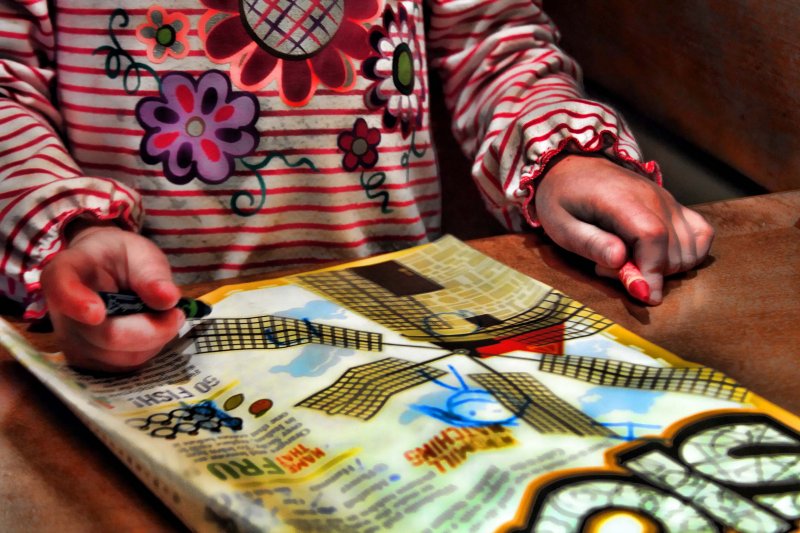 TWO LITTLE HANDS HOLDING TWO CRAYONS