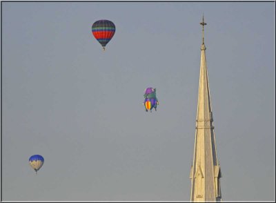 Three Balloons Behind Church Steeple
