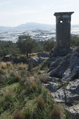 Pillar tomb and tombs on hill