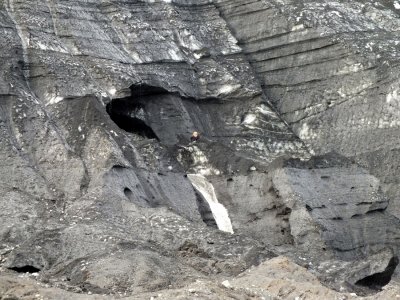 One of our guides climbed up on the glacier to cut away a piece of ice from the glacier