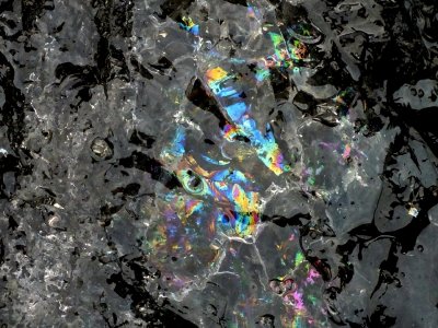 Various colors reflecting from inside the piece of ice