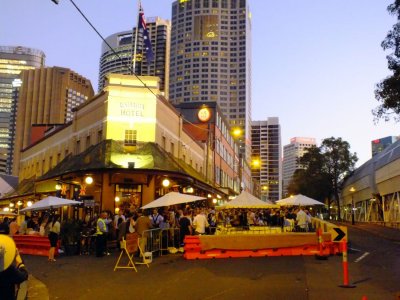 Celebrating Anzac Day - after attending morning memorial services, people gather in pubs, play a pub game of two-up, and drink 