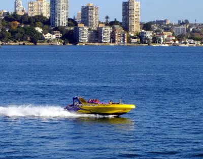A jet boat powering through Sydney Harbor
