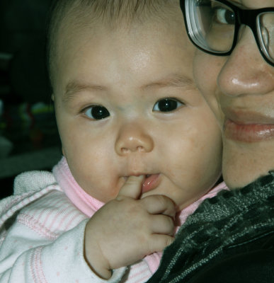 Mia in Auntie Thu*'s arms