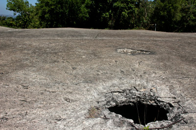 Scars of war - reminders abound of the kind of pounding the Japanese hailed towards the island. Artillery shell craters are all 