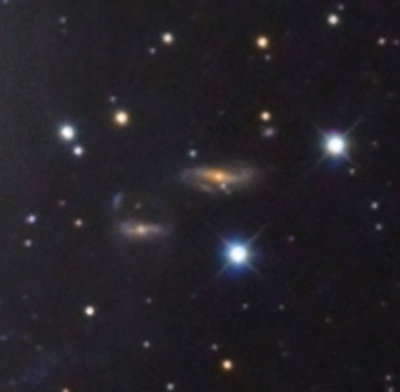 Two distant background galaxies next to M83