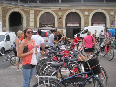 Versailles: Katie in the market with our bikes from Fat Tire. Please note the fresh baguettes in the basket on my bike. 
