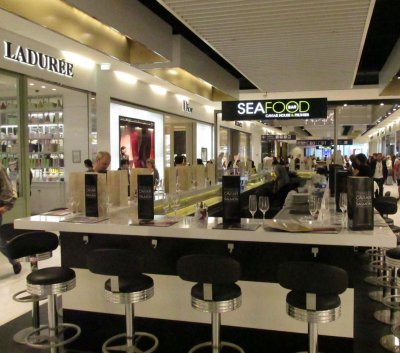 In case you still have any Euros left, the duty-free mall at CDG has Dior, Prada, Gucci,  and this champagne and caviar bar. 