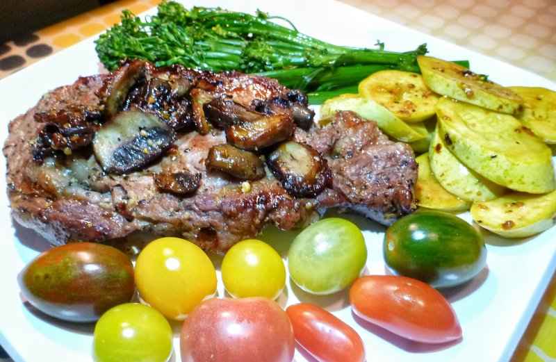 Angus Beef Rib Eye Steak with Sauted Mushrooms, Baby Broccoli, Yellow Squash and Heirloom Tomatoes