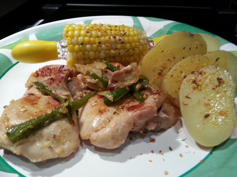 Chicken thighs with sliced onion & jalapenos, potatoes & corn on the cob