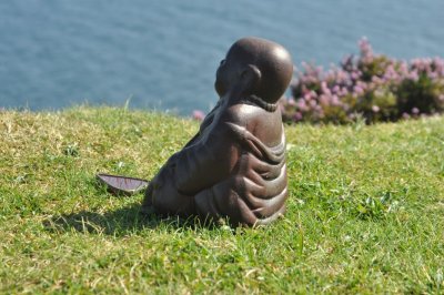 Buddha meditating overlooking the sea