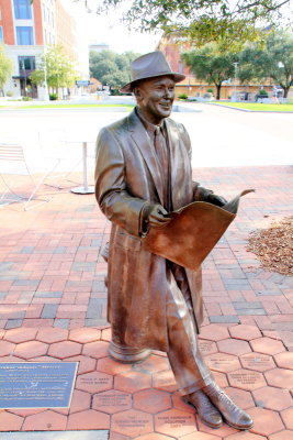 Man reading a magazine, statue, Ellis Square