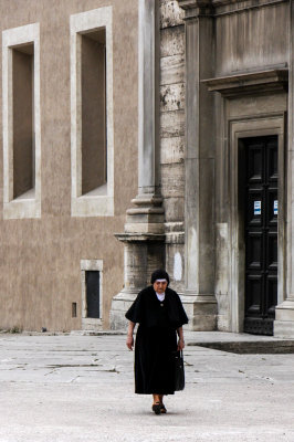 A lonely nun walks around Basilica of St.Paul Outside the Walls, Rome, Italy
