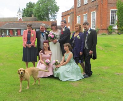 bride and groom with parents, bridesmaids and Mia