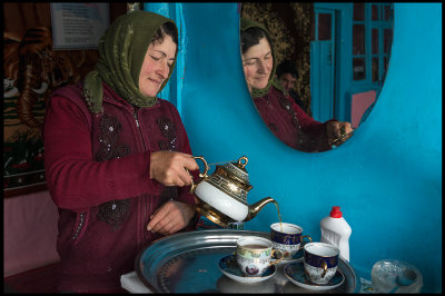 A woman preparing tea in Xinaliq teahouse