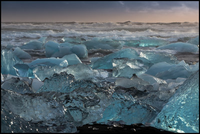 Ice from The huge glacier scattered on a lava beach near Jkulsarlon