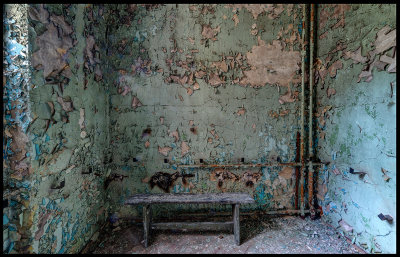 Lonely bench and old painted walls