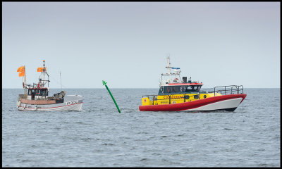 Rescue Boat Vringen towing a fishing boat in to Grnhgen harbor (land)