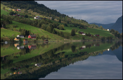 Small village Olden mirroring in the ocean - Norway