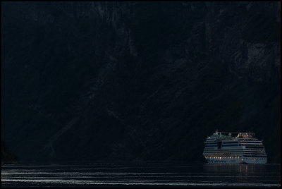 A ship leaving Geiranger late evening