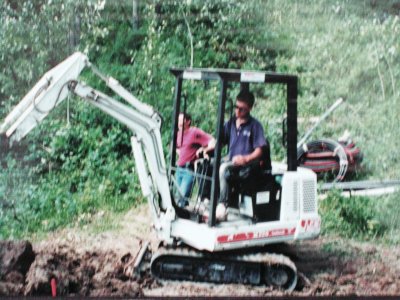 Stefan digging septic field for log house