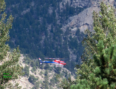 Helicopter crew seeks stranded people and evaluates Fish Creek flood damage - z P1090792 