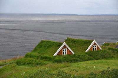 Original turf houses, volcanic plain behind