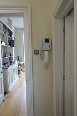 Is there any reason to have two entry phone consoles on the wall? The lower one is old. Does it even work?