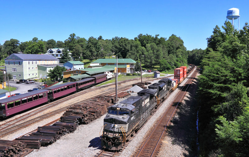Southbound stacks roll through Stearns as the Big South Fork train sits at the depot 