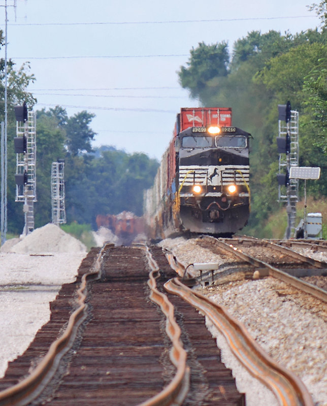 Train 215 passes the signals for the new CP woods, with ties and rail in place for the new track on the left 