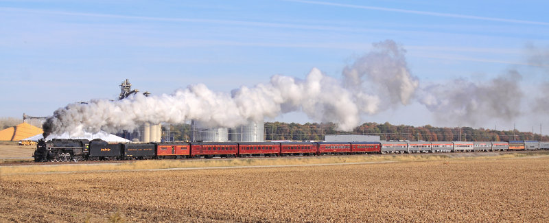 The train drifts through Clymers after crossing the CSX Diamond. Check out that massive pile of corn near the front of 765! 