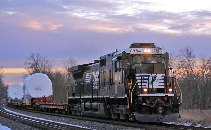 NS 053 eases up the main at Talmage under a colorful sunset 