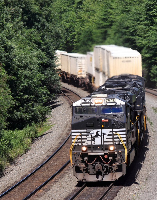 A paint splattered intermodal comes West on track 2 