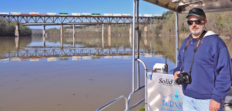 Butch Adkins enjoys the view from the water as NS 216 crosses the lake. 