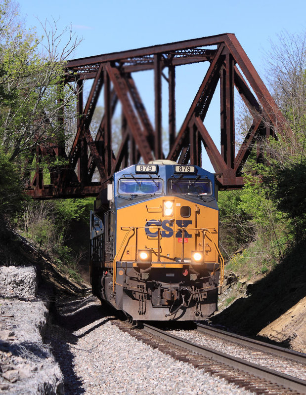 CSX R-573 South comes under the CNO&TP bridge at Walton , grinding up the long, twisting grade out of the Ohio River Valley 
