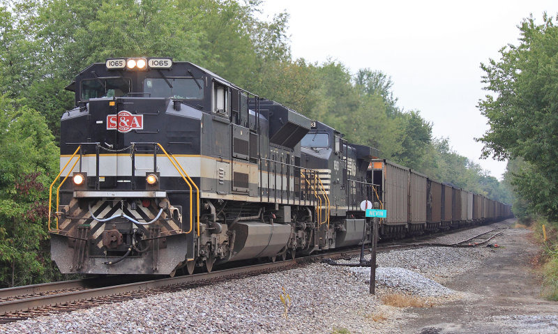 Eastbound 709 rolls through downtown Nevin on a cloudy morning 