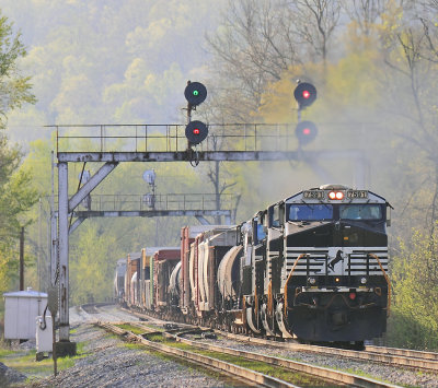 The morning fog still clings to the hillside as Northbound 116 comes under the signal bridge at Geneva 