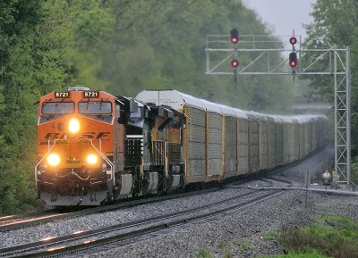 BNSF, NS and UP power bring I-39 by the East end of the siding at Waddy