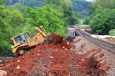 A CAT D8 dozer works  to re-profile the North approach to the Pittman Creek bridge 